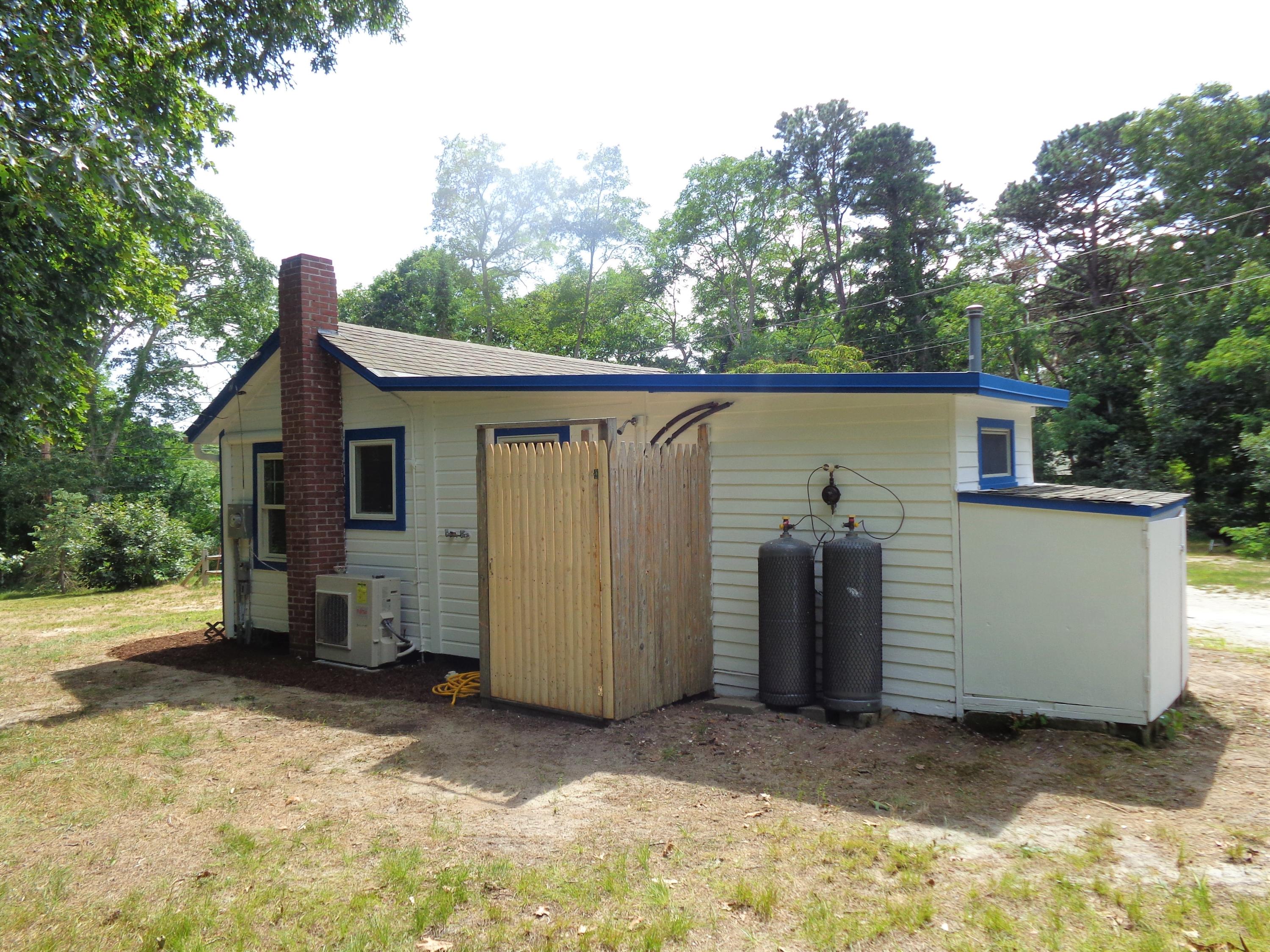 20 Baker Road, Unit C Wellfleet, MA 02667 - Photo 17 of 19 a view of a house with a backyard