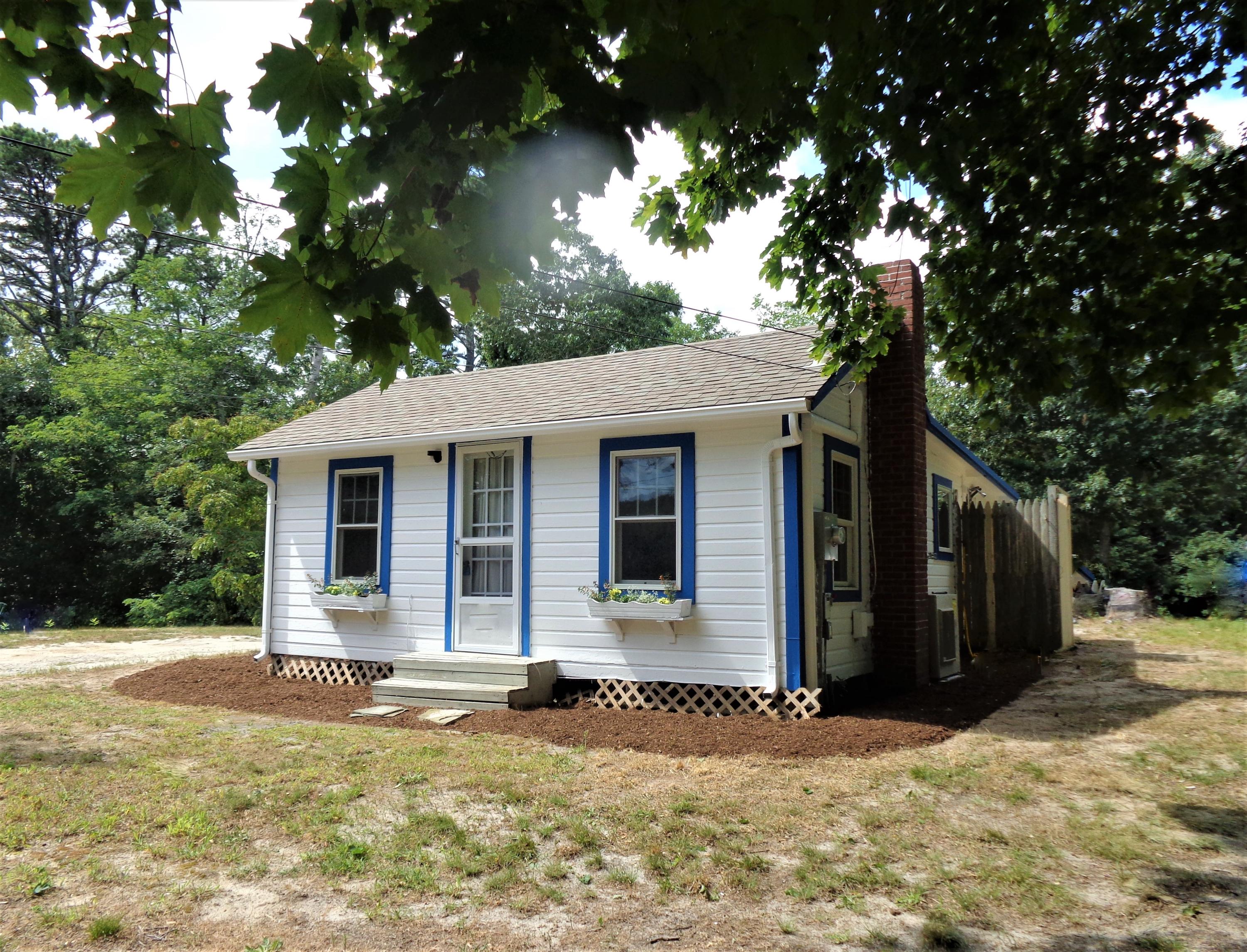 20 Baker Road, Unit C Wellfleet, MA 02667 - Photo 2 of 19 a front view of a house with a yard