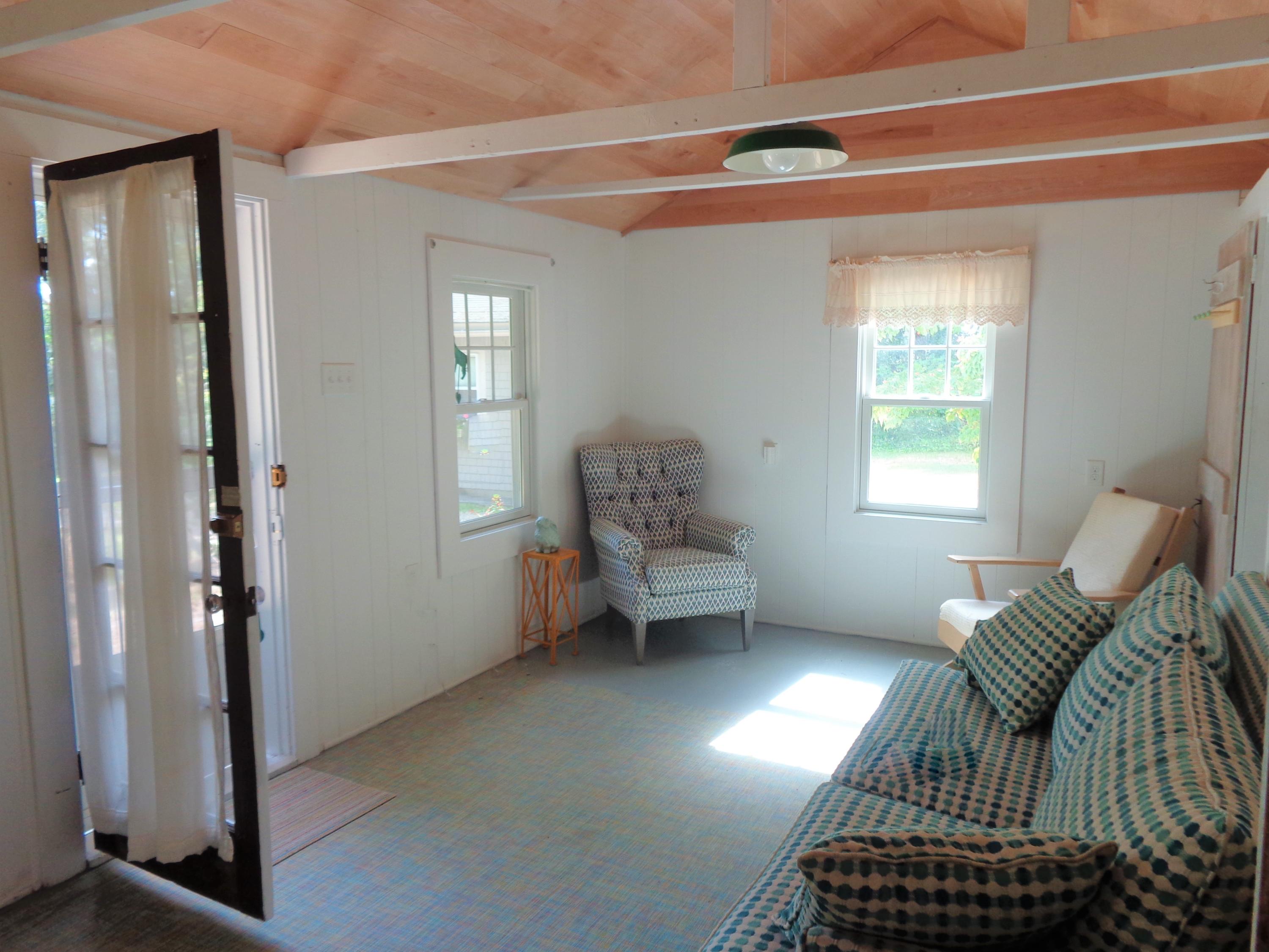 20 Baker Road, Unit C Wellfleet, MA 02667 - Photo 3 of 19 a living room with furniture a window and a potted plant