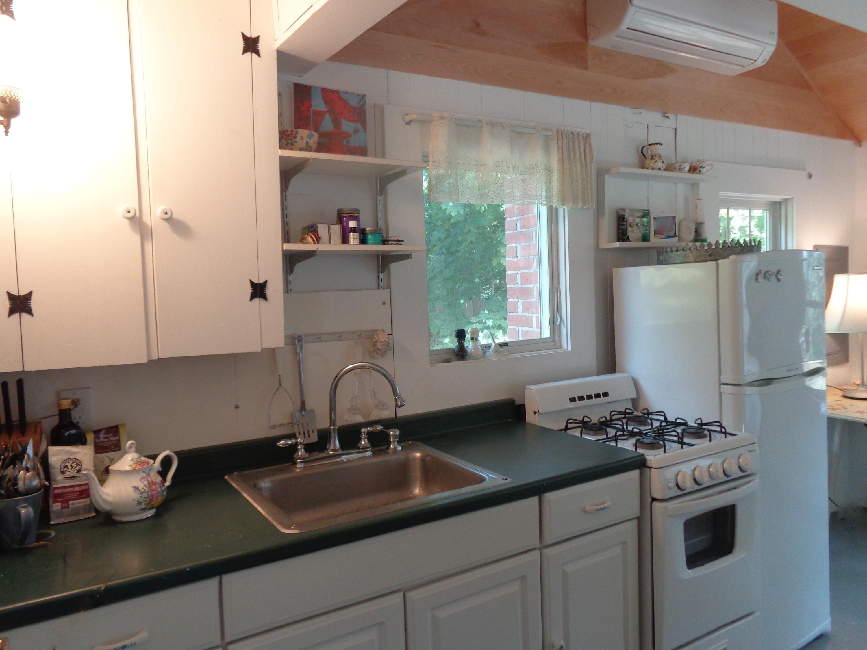 20 Baker Road, Unit C Wellfleet, MA 02667 - Photo 9 of 19 a kitchen with stainless steel appliances a sink stove and refrigerator