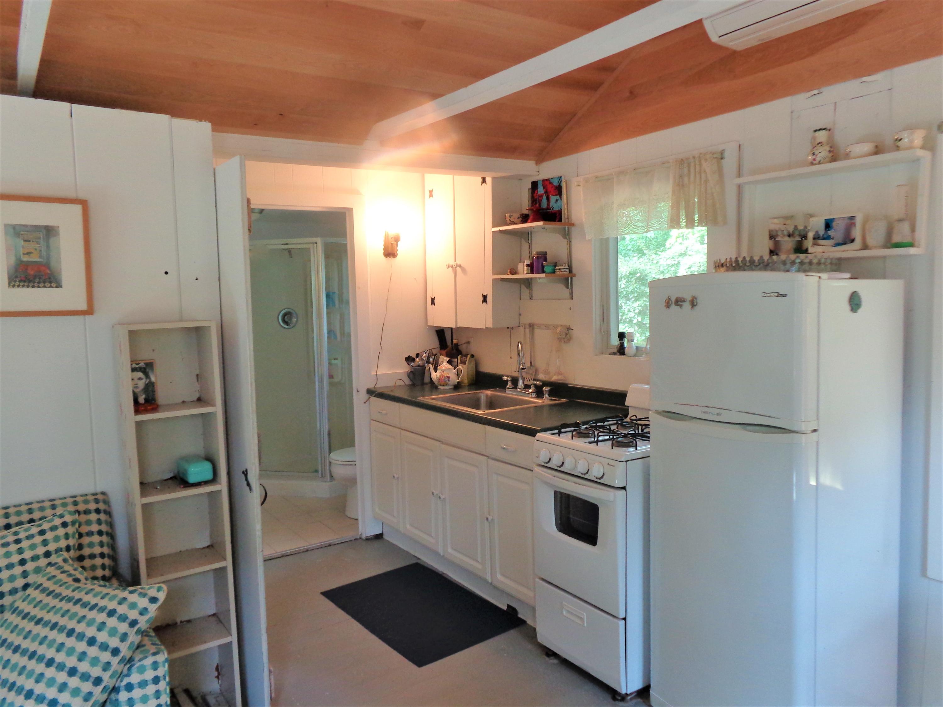 20 Baker Road, Unit C Wellfleet, MA 02667 - Photo 10 of 19 a kitchen with stainless steel appliances a refrigerator sink and cabinets
