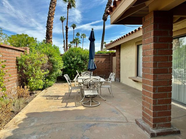 a view of a patio with table and chairs and potted plants