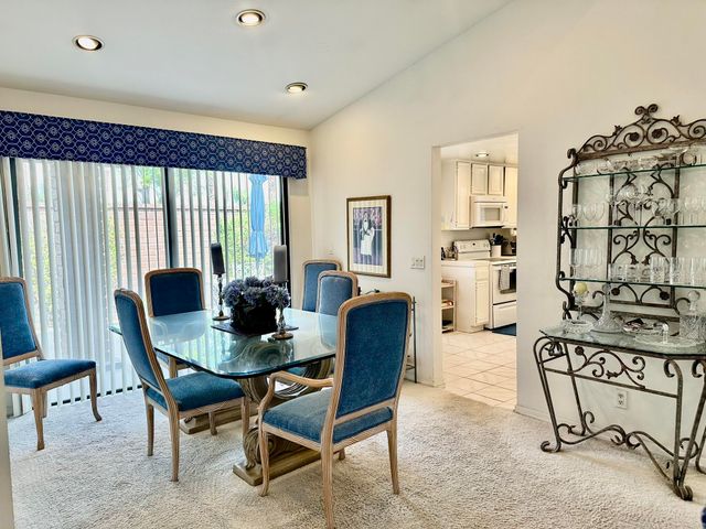 a view of a dining room with furniture and a window