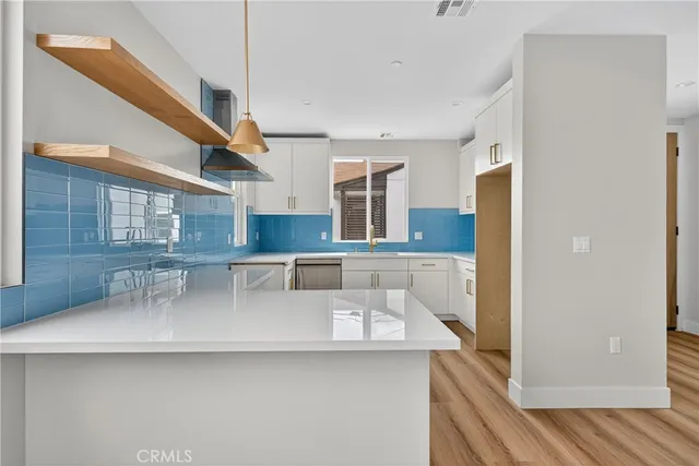 a kitchen with stainless steel appliances granite countertop a sink a stove and a refrigerator