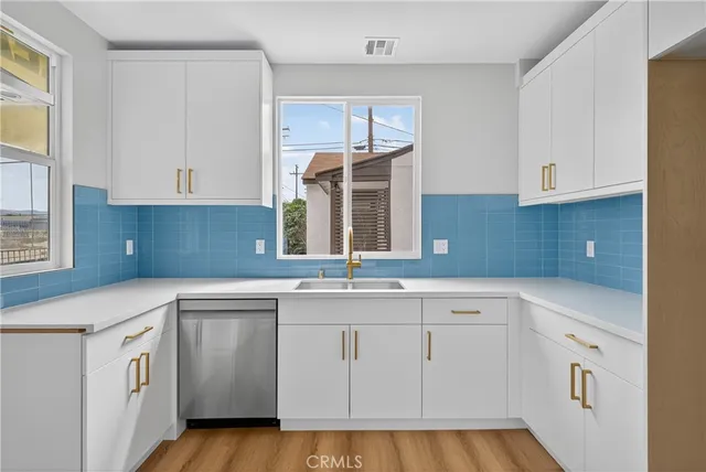 a kitchen with white cabinets and white appliances