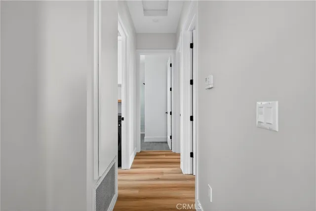 a view of a hallway with wooden door