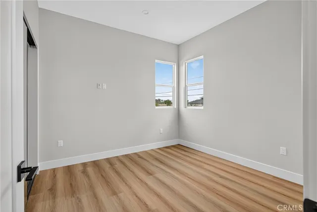 a view of room with window and hardwood floor