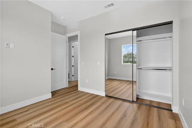 a view of hallway with wooden floor