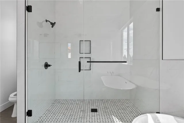 a bathroom with a sink toilet and shower