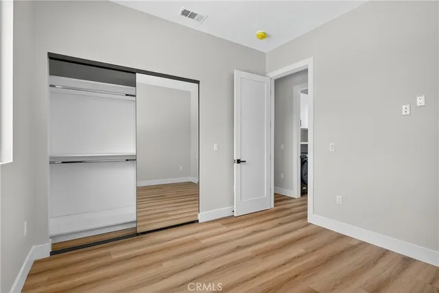 a view of an empty room and wooden floor