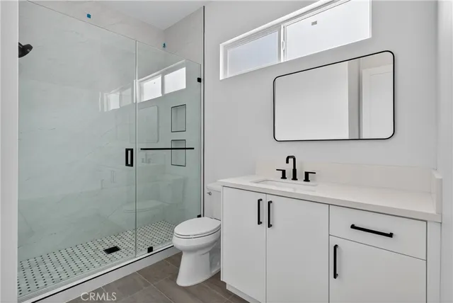 a bathroom with a toilet sink and shower