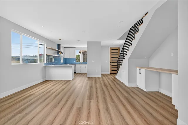 a view of a kitchen with wooden floor and stairs