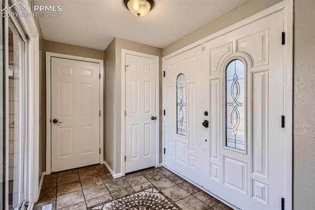 1320 Wooten Road Colorado Springs, CO 80915 - Photo 3 of 26 Custom tile foyer