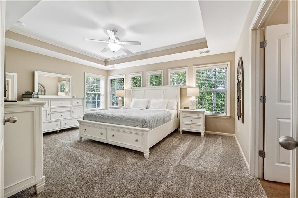 2770 Lansing Lane Cumming, GA 30041 - Photo 16 of 49 a bedroom with a bed and a chandelier