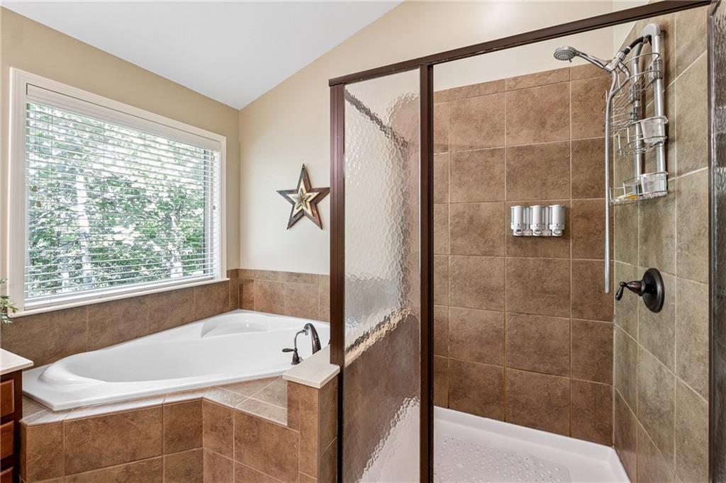 2770 Lansing Lane Cumming, GA 30041 - Photo 19 of 49 a white bath tub sitting next to a shower