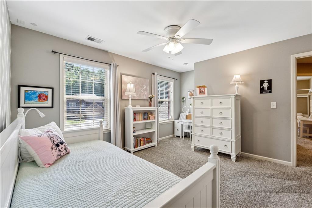 2770 Lansing Lane Cumming, GA 30041 - Photo 24 of 49 a bedroom with a bed and a cabinets