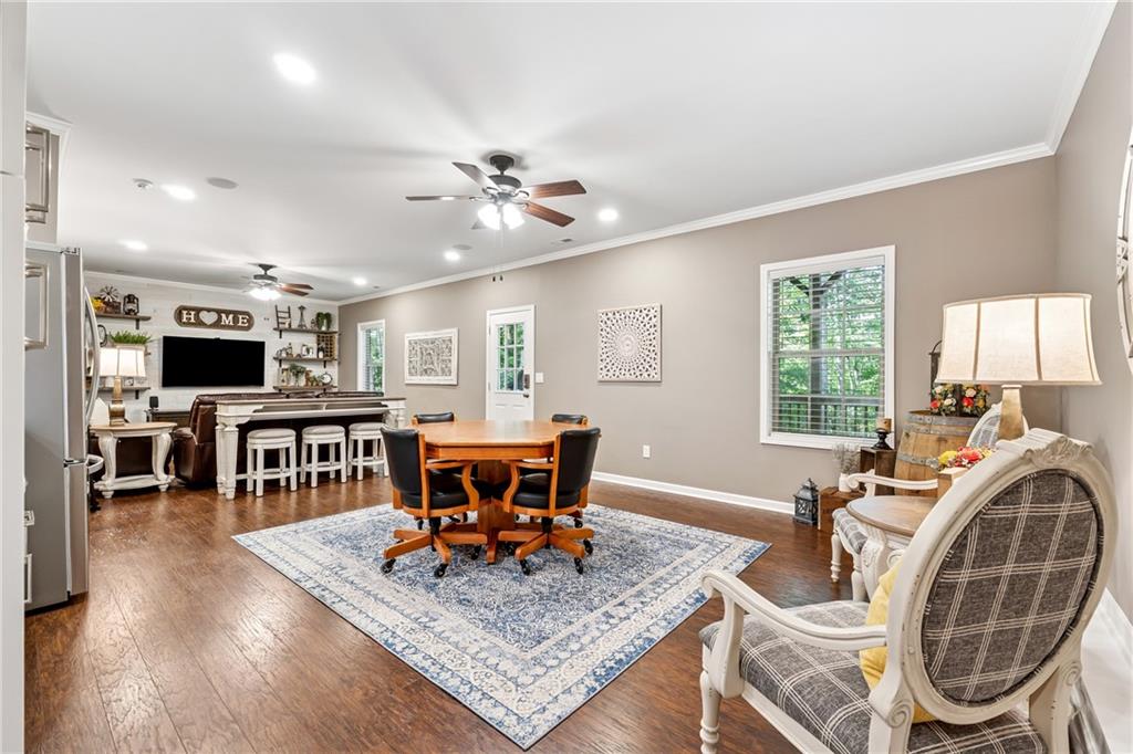 2770 Lansing Lane Cumming, GA 30041 - Photo 28 of 49 a living room with furniture a flat screen tv and a large window
