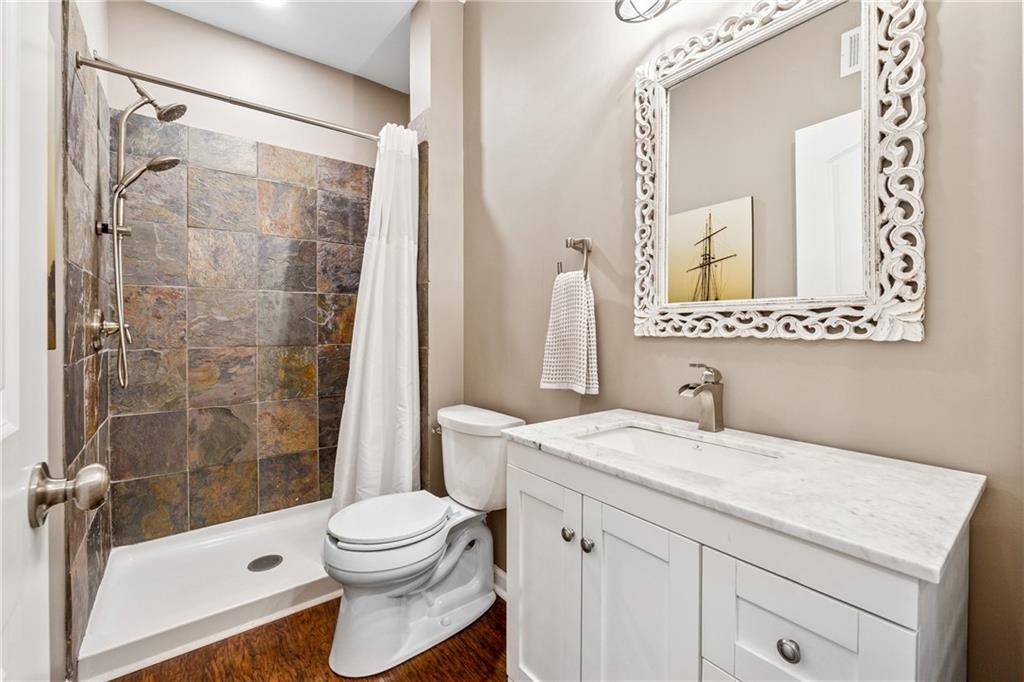 2770 Lansing Lane Cumming, GA 30041 - Photo 33 of 49 a bathroom with a sink a toilet and a mirror