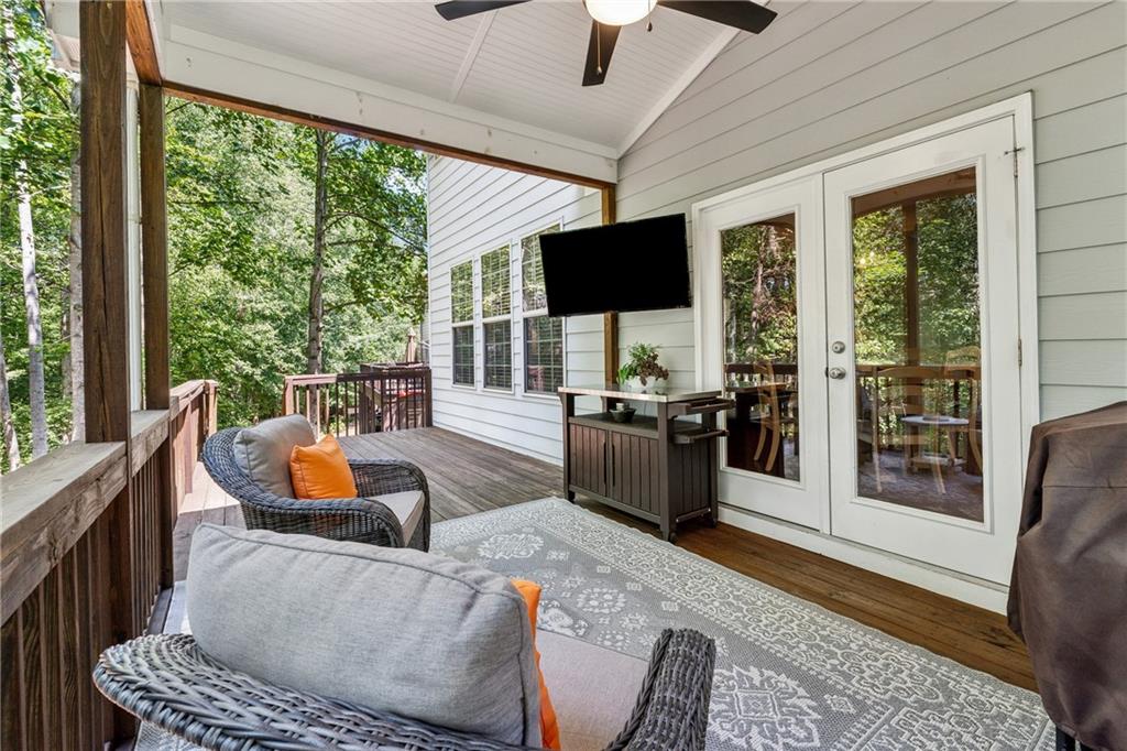 2770 Lansing Lane Cumming, GA 30041 - Photo 34 of 49 a living room with furniture a flat screen tv and a large window