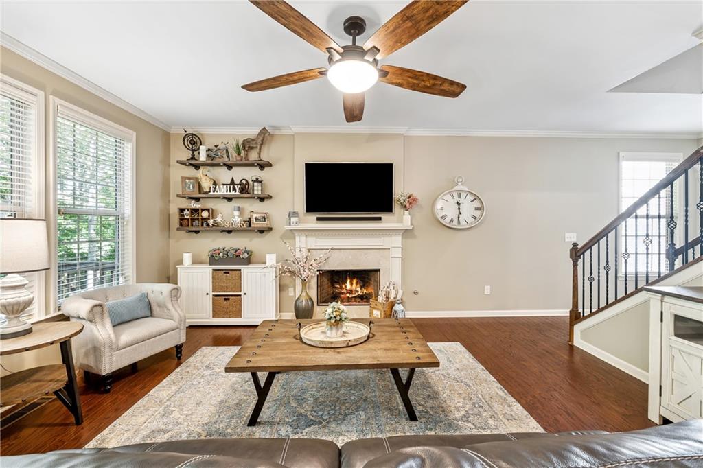 2770 Lansing Lane Cumming, GA 30041 - Photo 9 of 49 a living room with furniture a fireplace and a flat screen tv