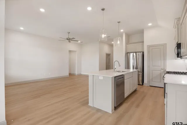 a kitchen with a sink stove and refrigerator