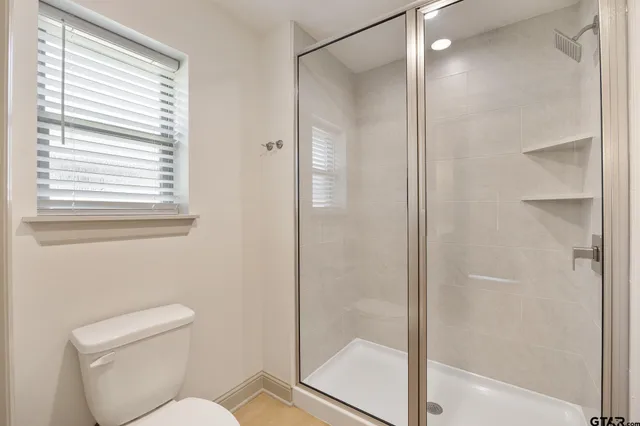 a bathroom with a glass shower door