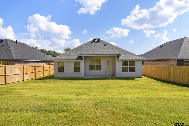 a front view of house with yard and trees