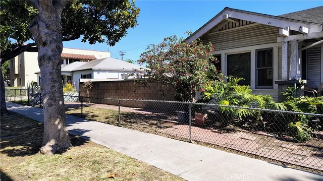 a backyard of a house with flower plants