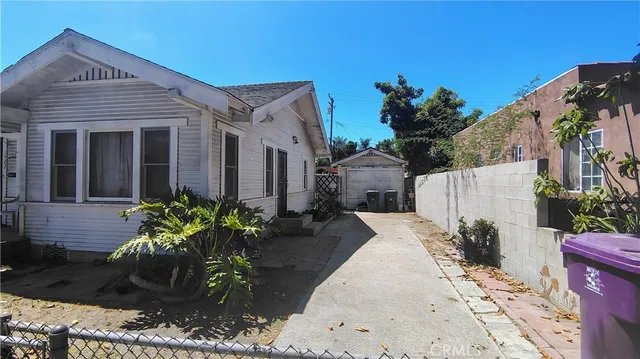 a view of a house with potted plants