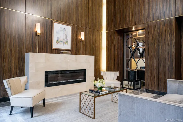 a living room with furniture a fireplace and a window