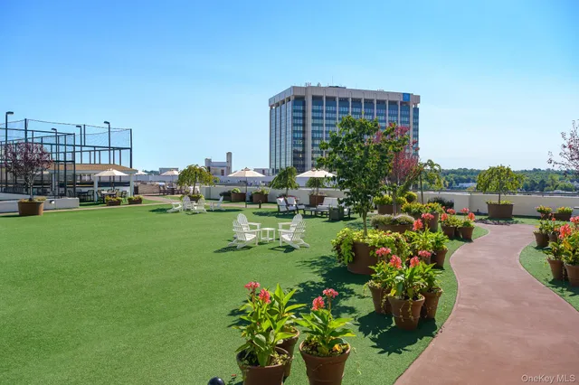 a view of a garden with flowers and buildings