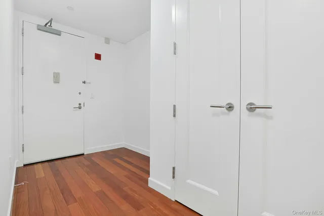 a view of a room with wooden floor and white walls