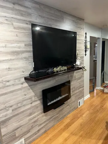 a living room with a flat screen tv and a fireplace