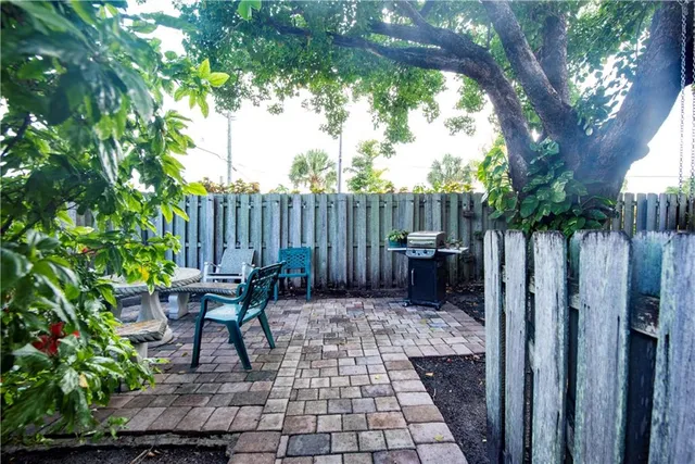 a view of a bench in backyard of the house
