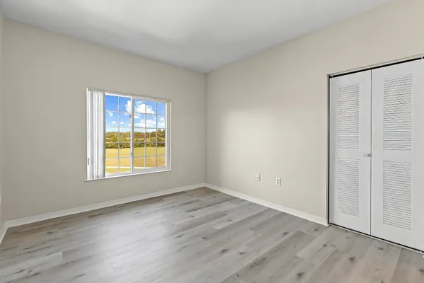 a view of an empty room and wooden floor
