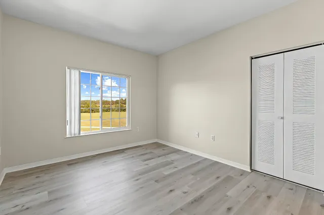 a view of an empty room and wooden floor