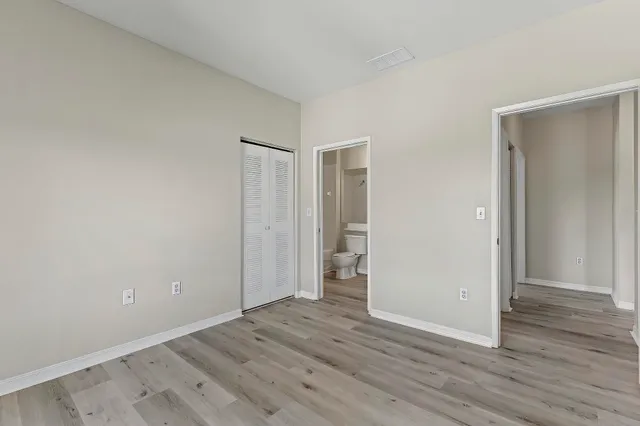 a bathroom with a sink a toilet and a large mirror