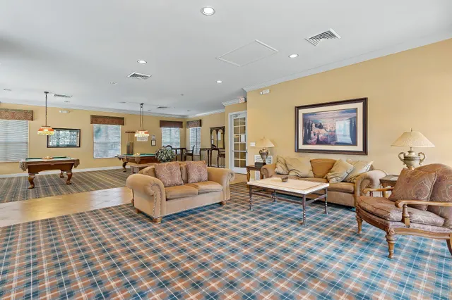 a living room with furniture large window and a table