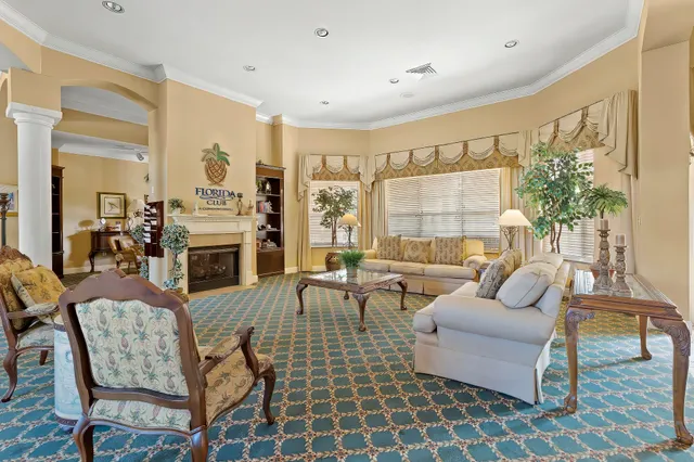 a room with pool table and windows