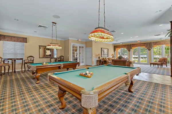 a kitchen with granite countertop a table chairs stove and cabinets