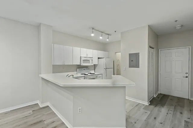 a kitchen with kitchen island sink stove and refrigerator