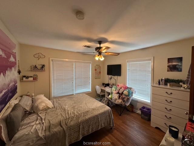 313 Laurel Street Bryan, TX 77801 - Photo 7 of 16 a bedroom with a bed and wooden floor