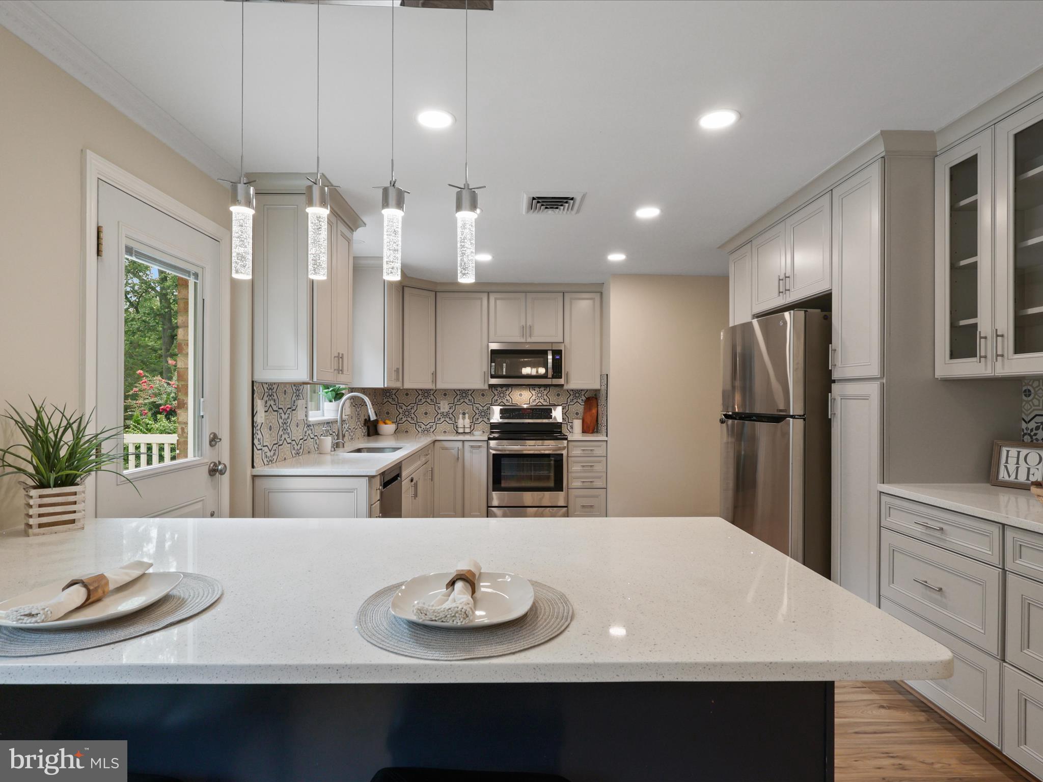 4417 Laurel Road Alexandria, VA 22309 - Photo 10 of 46 a view of kitchen with stainless steel appliances granite countertop a sink dishwasher a refrigerator and white cabinets with wooden floor