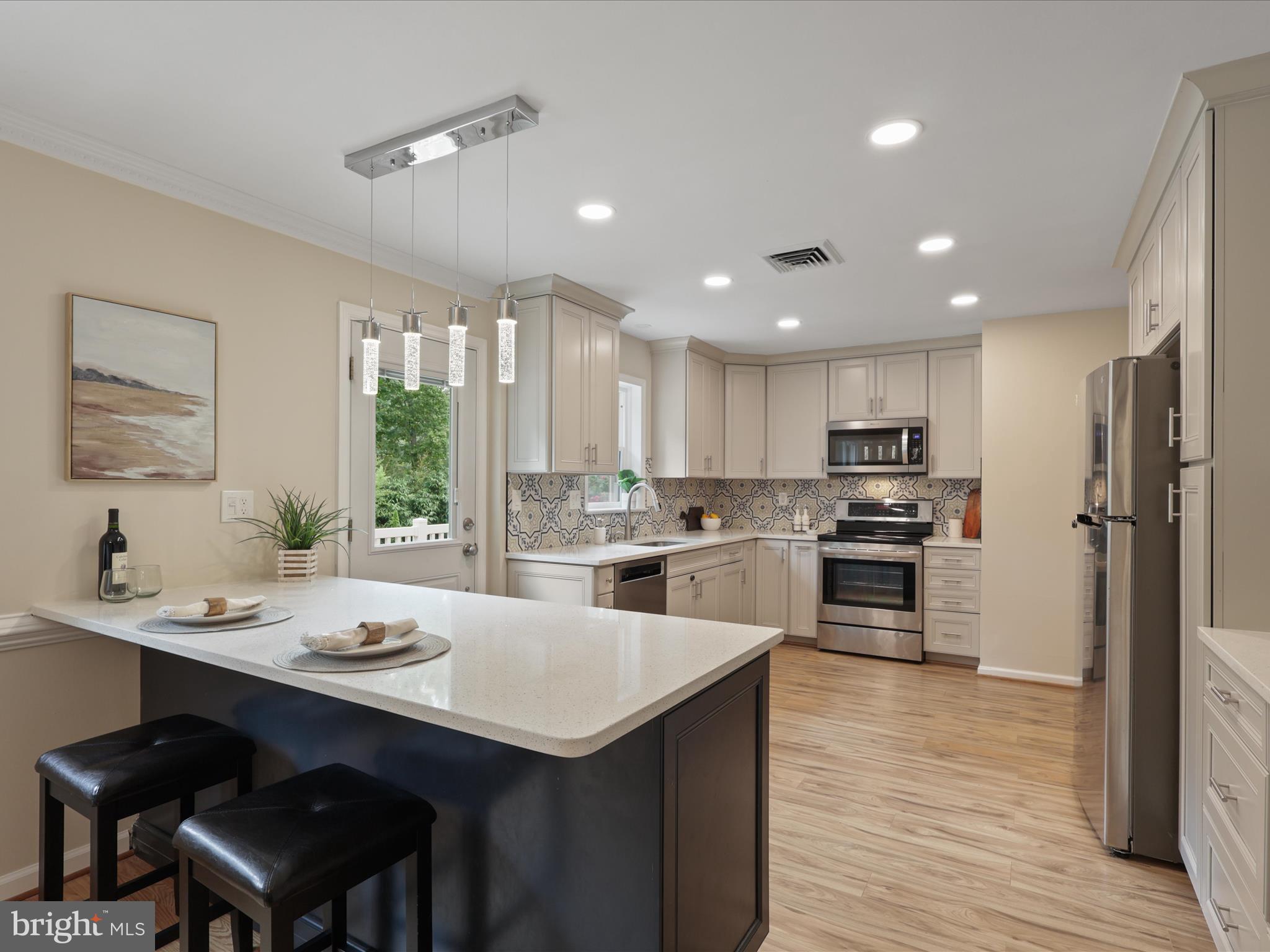4417 Laurel Road Alexandria, VA 22309 - Photo 11 of 46 a kitchen with refrigerator cabinets and wooden floor