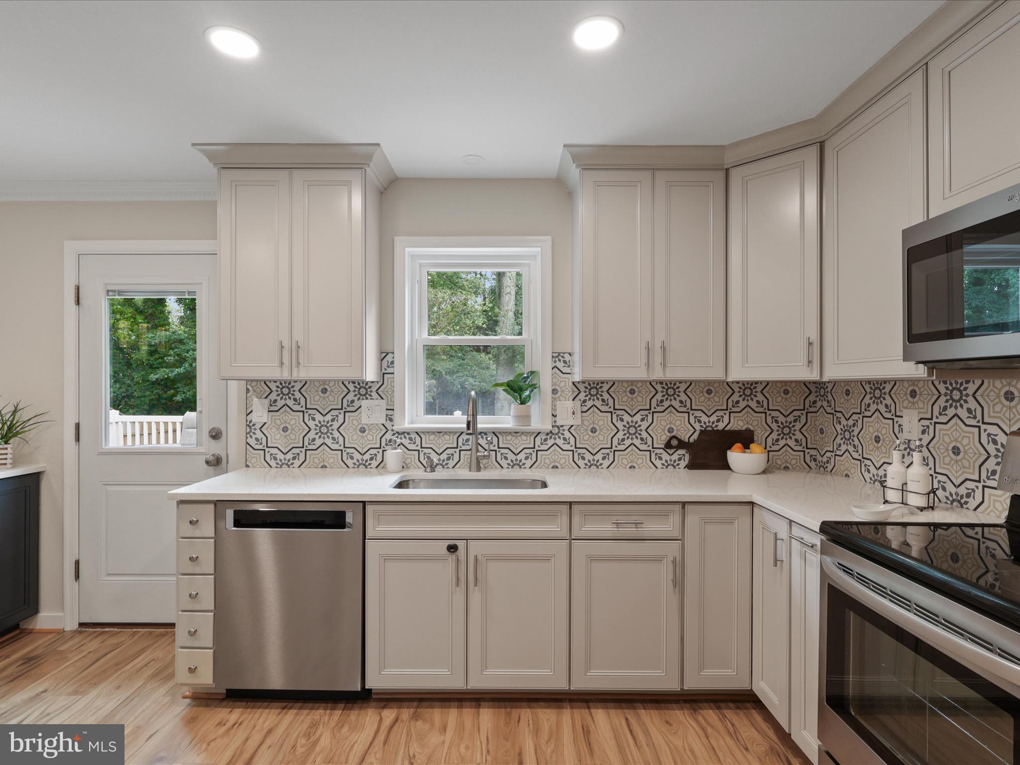 4417 Laurel Road Alexandria, VA 22309 - Photo 12 of 46 a kitchen with a sink stove and cabinets