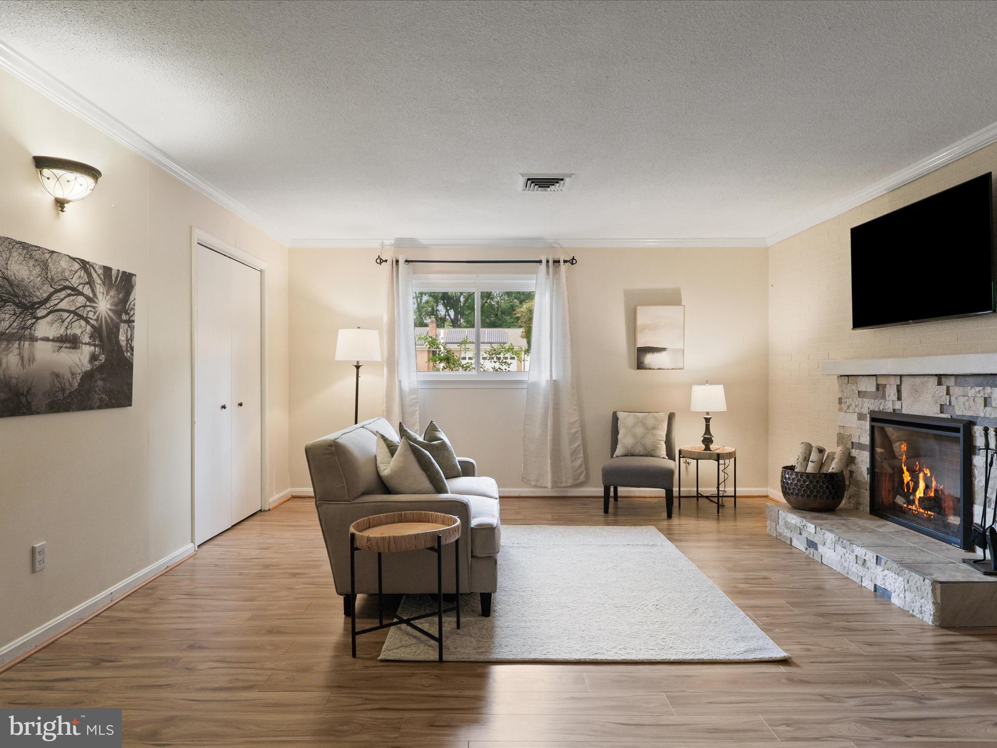 4417 Laurel Road Alexandria, VA 22309 - Photo 22 of 46 a living room with furniture fireplace and flat screen tv