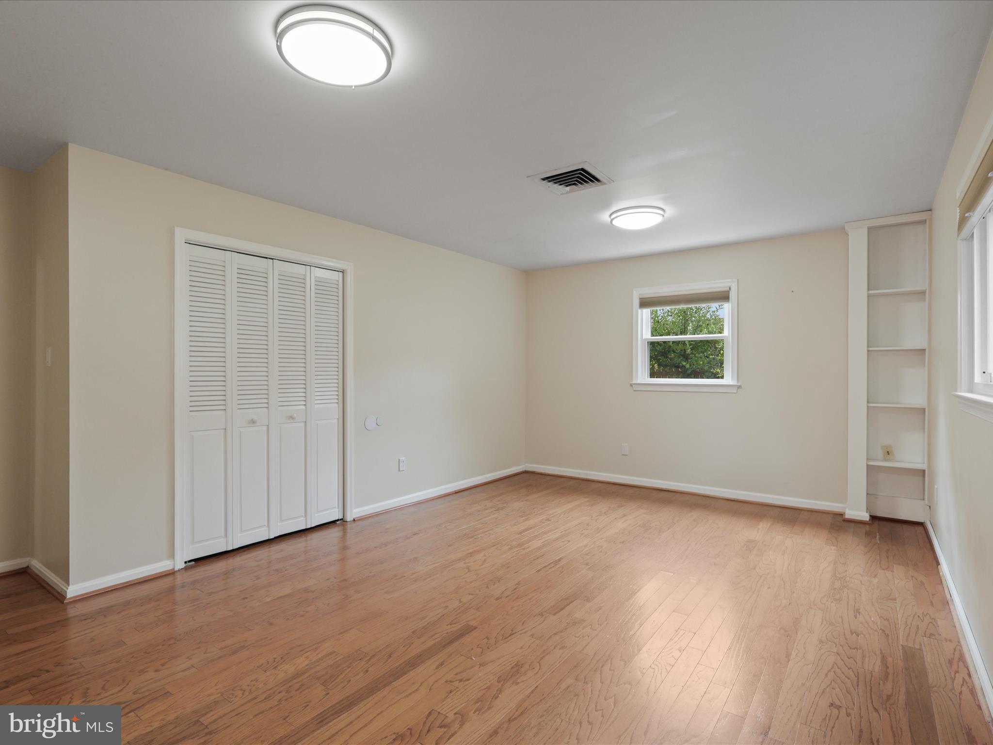 4417 Laurel Road Alexandria, VA 22309 - Photo 26 of 46 an empty room with wooden floor and windows