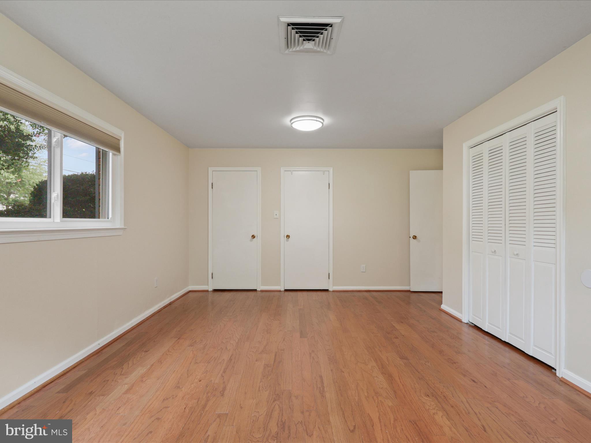 4417 Laurel Road Alexandria, VA 22309 - Photo 27 of 46 a view of an empty room with wooden floor and a window