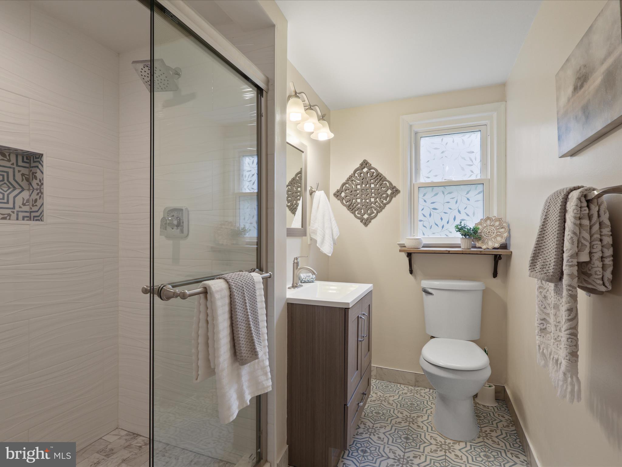 4417 Laurel Road Alexandria, VA 22309 - Photo 29 of 46 a bathroom with a granite countertop toilet sink and shower