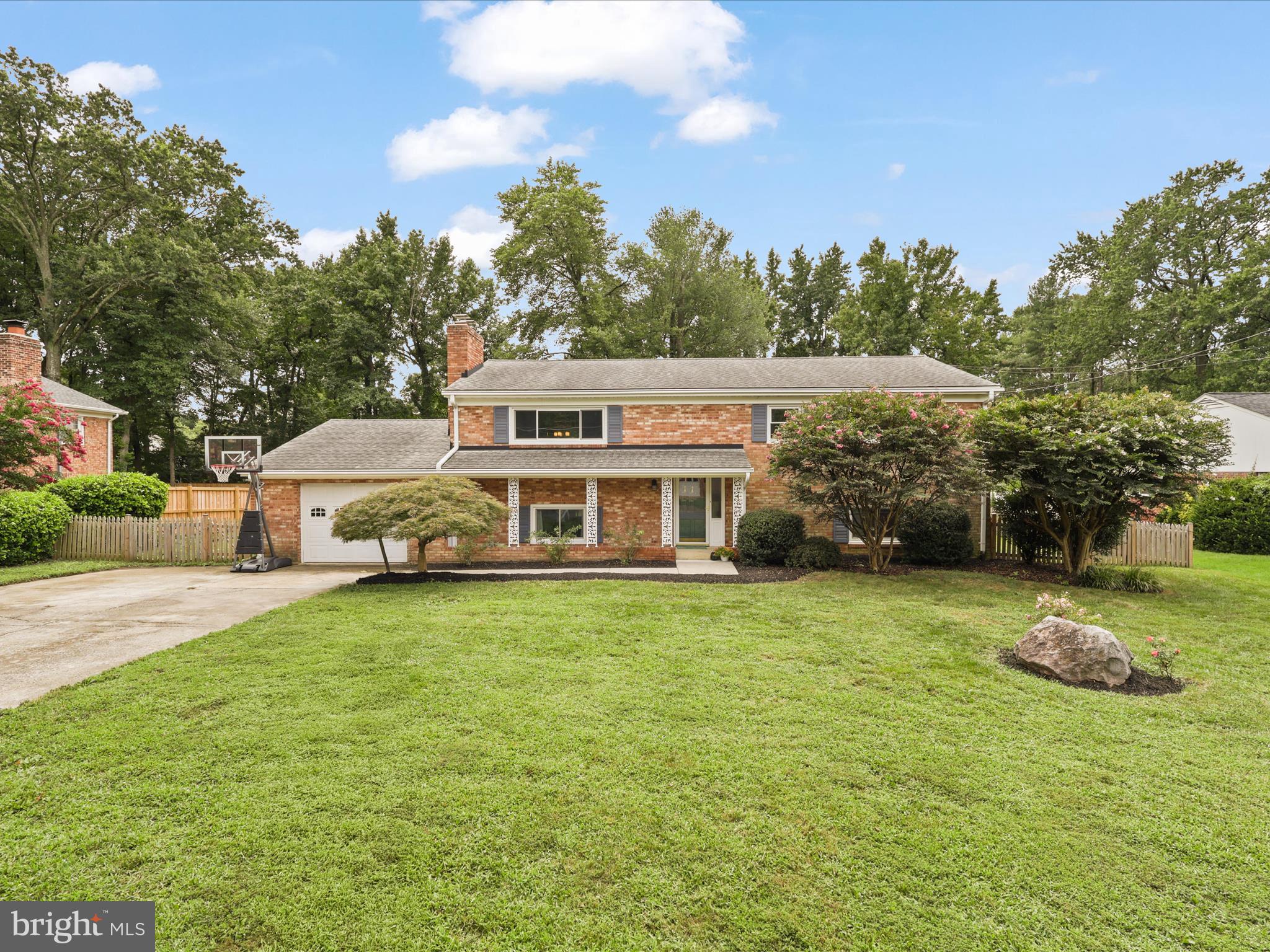 4417 Laurel Road Alexandria, VA 22309 - Photo 3 of 46 a front view of a house with a garden and trees